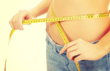 Slim woman measuring her waist. clipart