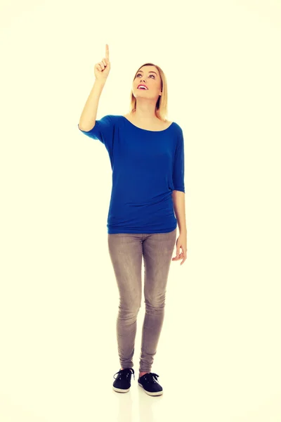Beautiful woman pointing up. — Stock Photo, Image