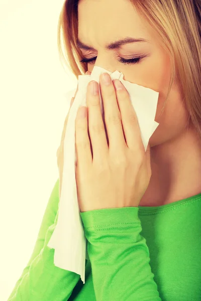 Woman sneezing to tissue. — Stock Photo, Image