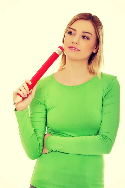 Thoughtful woman with big pencil. — Stock Photo, Image