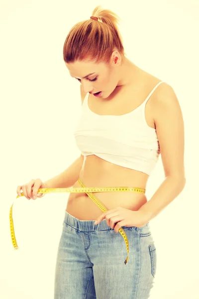 Mujer conmocionada midiendo su cintura . — Foto de Stock