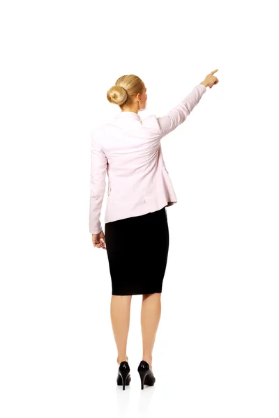 Back view of young business  woman pointing for somathing — Stock Photo, Image