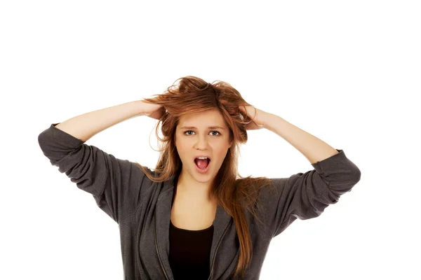 Young surprised woman holding hands inside hair — Stock Photo, Image