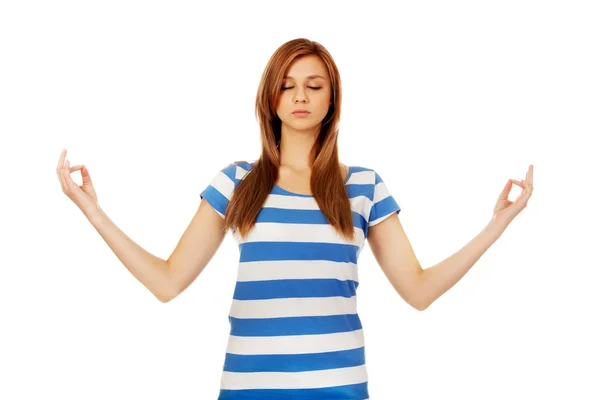 Teenage woman makes meditating gesture — Stock Photo, Image