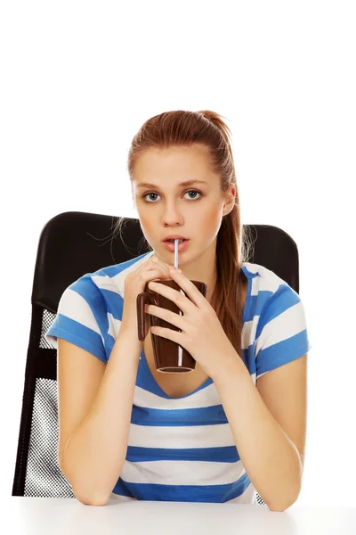 Teenage woman drinking something through straw — Stock Photo, Image