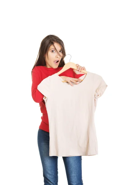 Shocked woman with a new shirt. — Stock Photo, Image