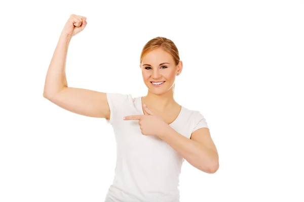 Funny young woman showing her muscles — Stock Photo, Image