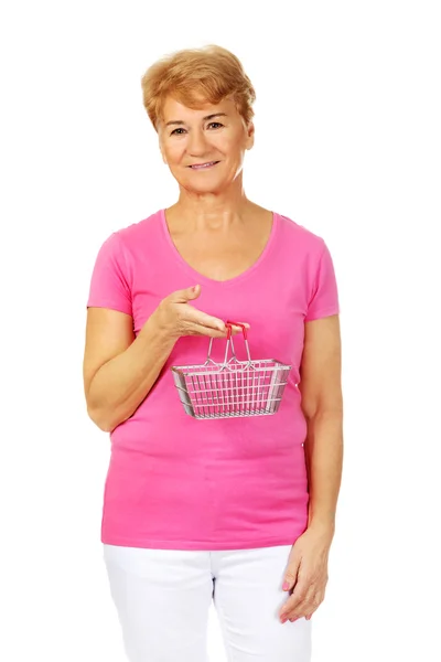 Senior smiling woman holding mini shopping basket — Stock Photo, Image