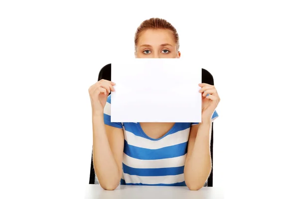 Teenage woman covering face with paper card — Stock Photo, Image