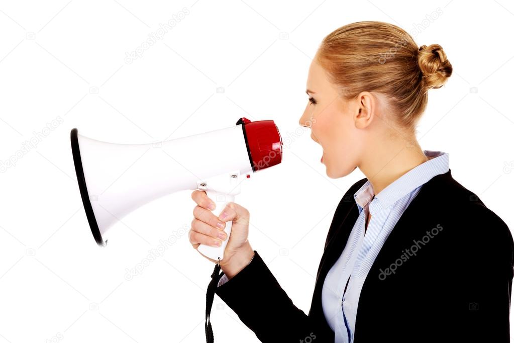 Young business woman screaming through megaphone