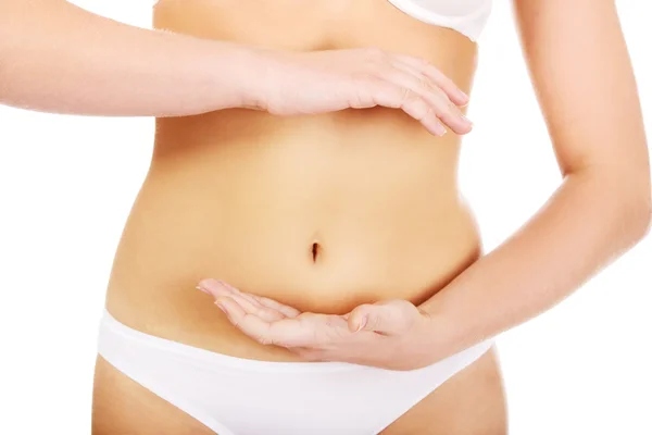 Slim woman belly with hand on it — Stock Photo, Image