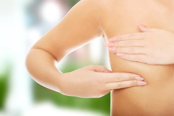 Woman examining breast — Stock Photo, Image