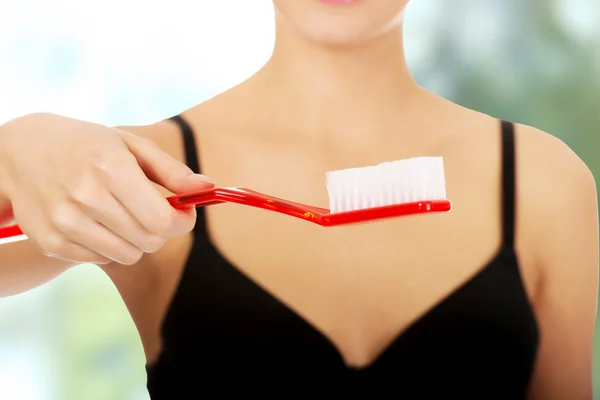 Woman with oversized toothbrush. — Stock Photo, Image