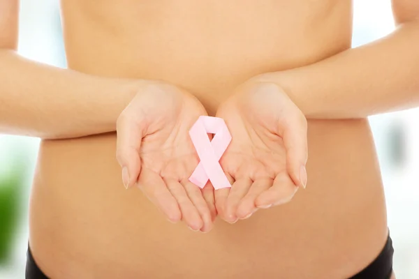 Female hands holding pink ribbon. — Stock Photo, Image