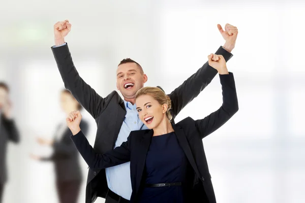 Victorious business couple with hands up — Stock Photo, Image