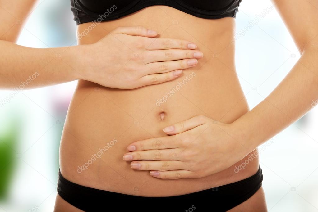 Woman touching her belly.