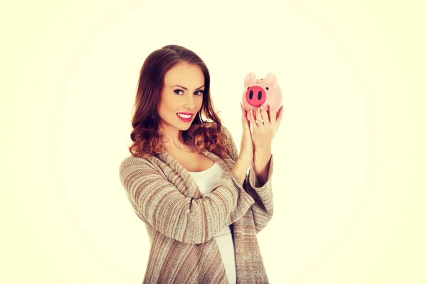 Gelegenheitsfrau mit Sparschwein. — Stockfoto