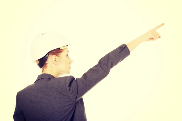 Businesswoman in hard hat pointing up. — Stock Photo, Image