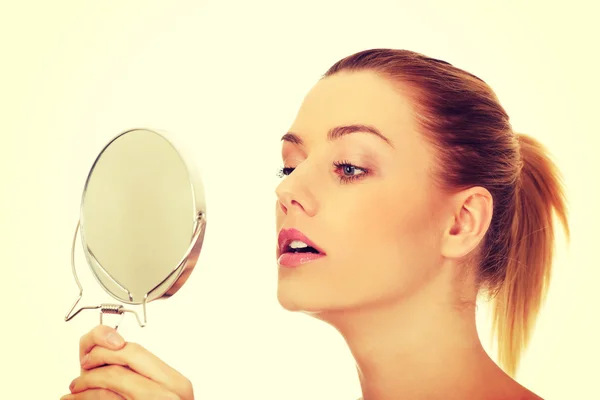 Young woman holding a mirror. — Stock Photo, Image