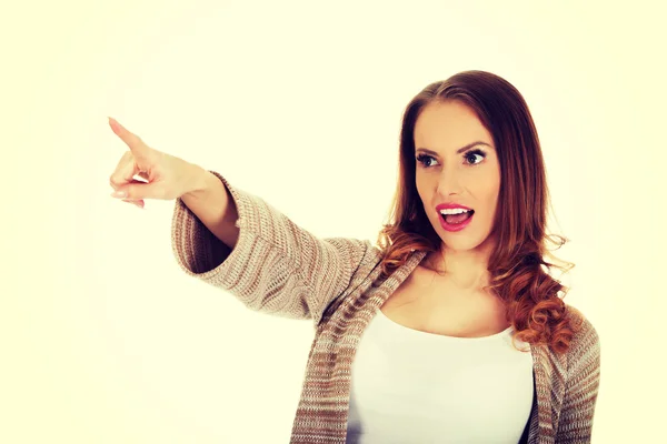 Shocked woman pointing away. — Stock Photo, Image