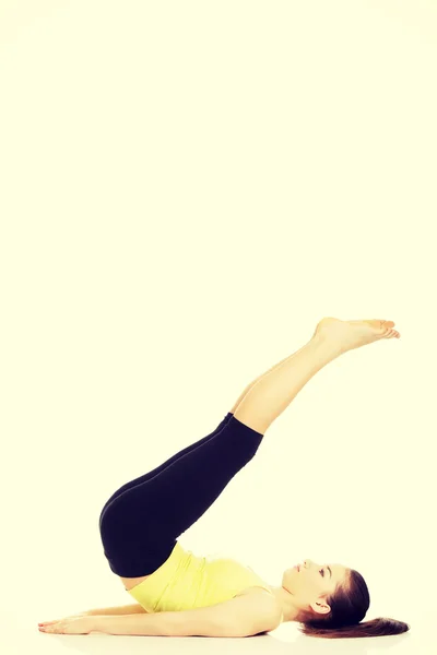 Fitness woman with her legs up. — Stock Photo, Image