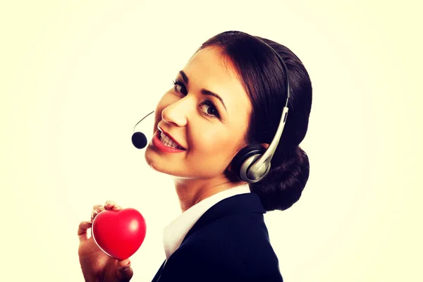 Call center woman holding heart model — Stock Photo, Image