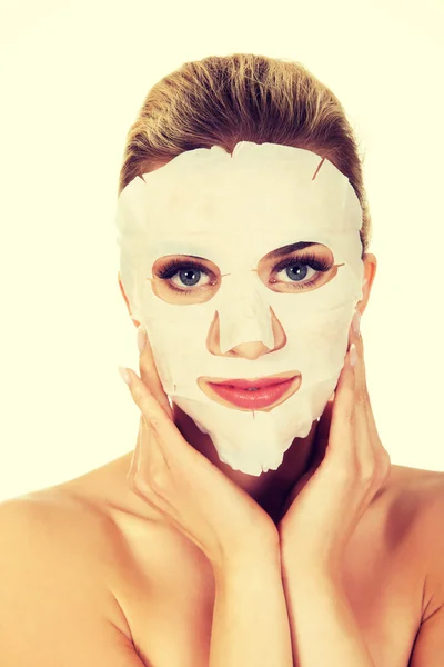 Young woman with facial mask — Stock Photo, Image