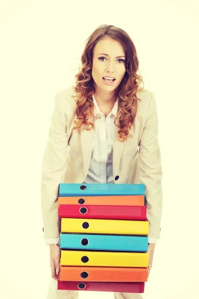 Female carrying heavy binders against. — Stock Photo, Image