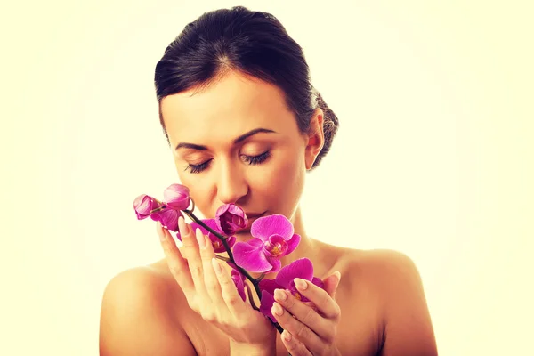 Topless woman with purple orchid branch — Stock Photo, Image