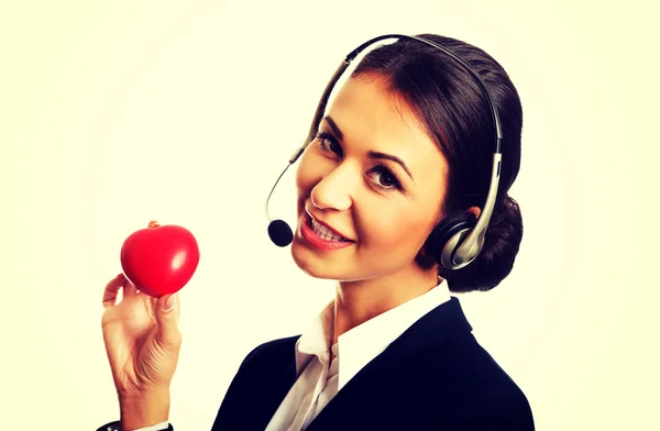 Call center woman holding heart model — Stock Photo, Image