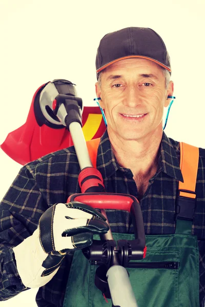 Gardener with trimmer and ear protectors — Stock Photo, Image