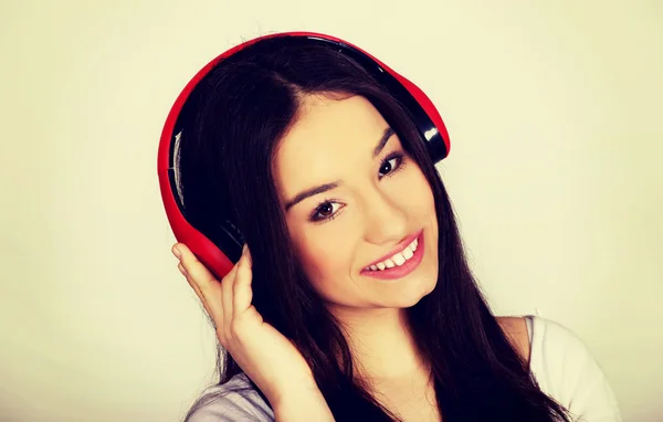 Rock woman with headphones listening to music. — Stock Photo, Image