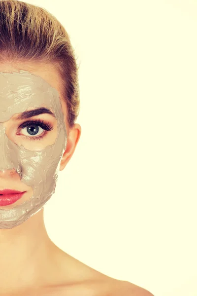 Metade rosto de mulher jovem com máscara facial — Fotografia de Stock