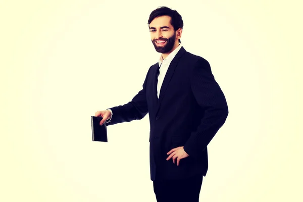 Young businessman holding copy space. — Stock Photo, Image