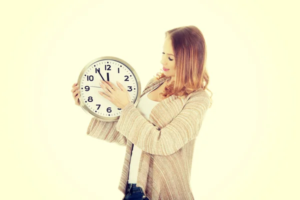 Woman changes clock leads. — Stock Photo, Image