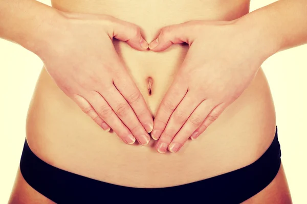 Frau mit den Händen auf dem Bauch. — Stockfoto