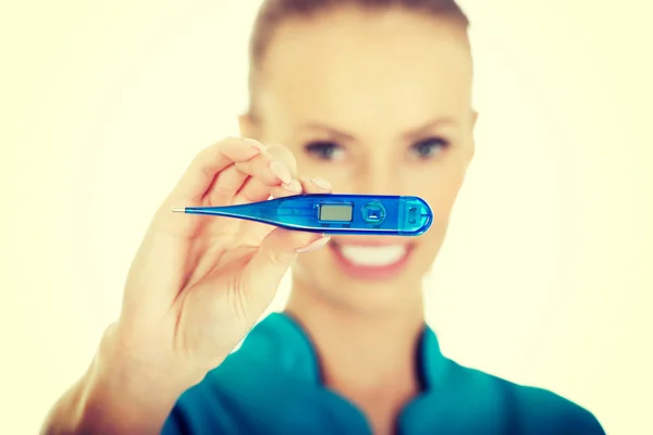 Attractive doctor with a thermometer. — Stock Photo, Image