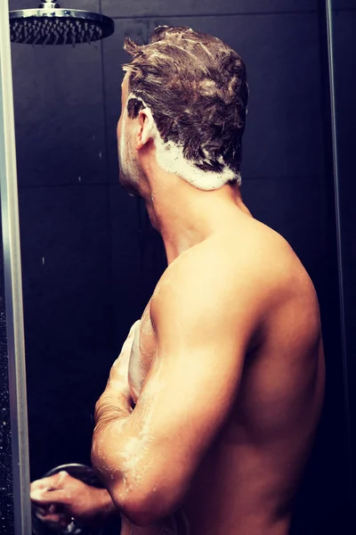 Handsome man washing himself with soap. — Stock Photo, Image