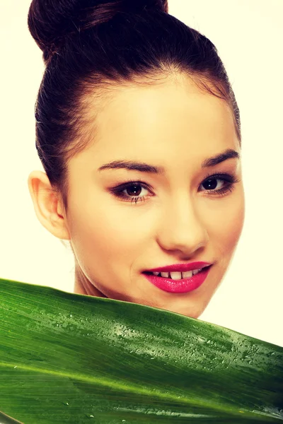 Beautiful woman with green leaf. — Stock Photo, Image