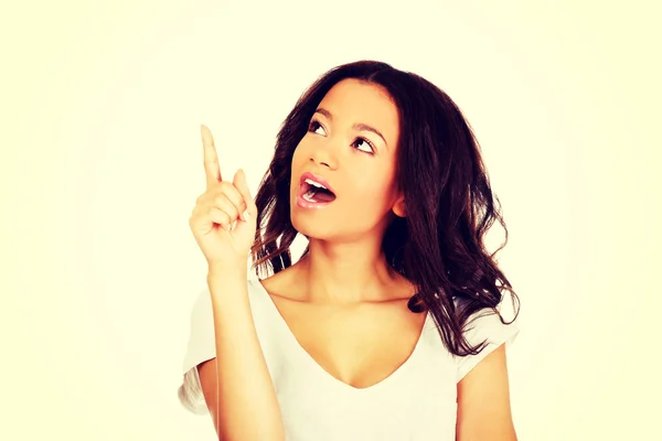 Young woman pointing up. — Stock Photo, Image