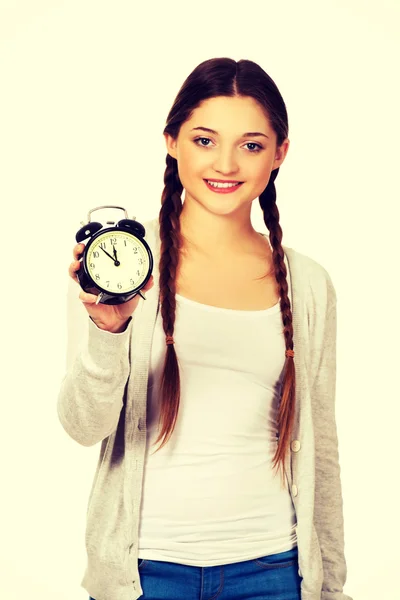 Happy teenage woman with alarmclock. — Stock Photo, Image