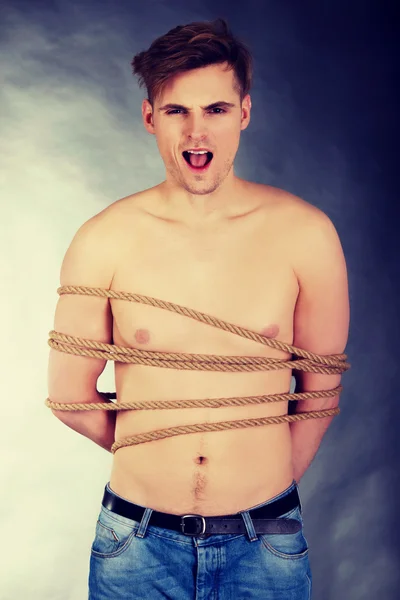 Tortured man tied with a rope. — Stock Photo, Image