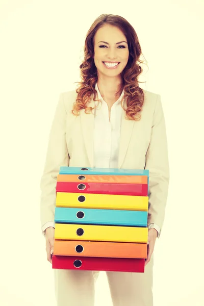 Female carrying heavy binders against. — Stock Photo, Image