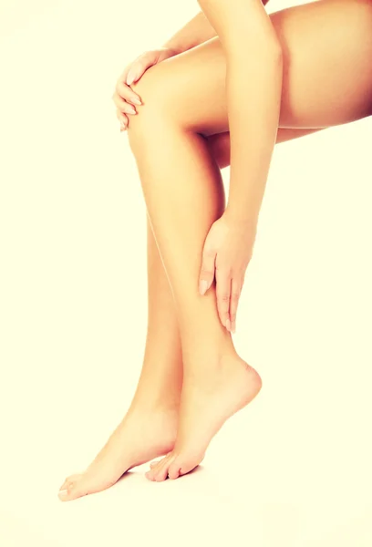 Woman cares about her legs. Stock Photo