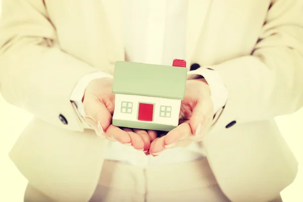 Businesswoman presenting a model house. Stock Picture