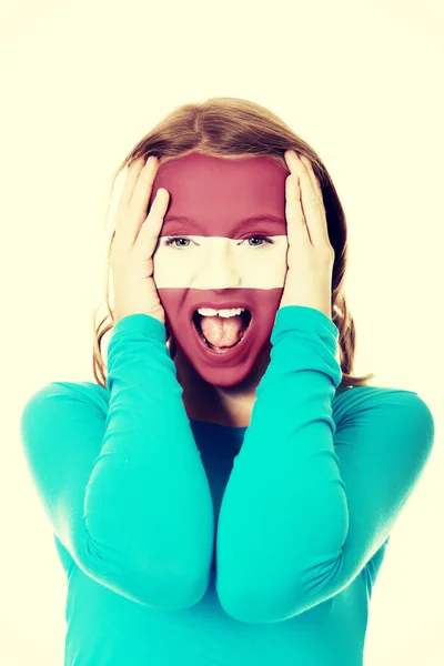 Mujer con bandera de Letonia en la cara . —  Fotos de Stock