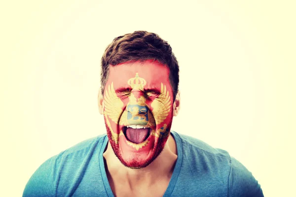 Screaming man with Montenergro flag on face. — Stock Photo, Image