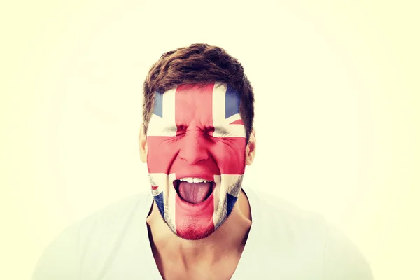 Homem gritando com a bandeira da Grã-Bretanha na cara . — Fotografia de Stock
