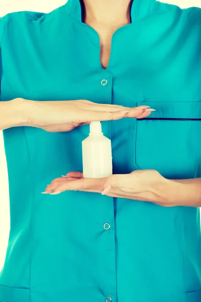 Nurse in uniform with hydrogen peroxide. — Stock Photo, Image