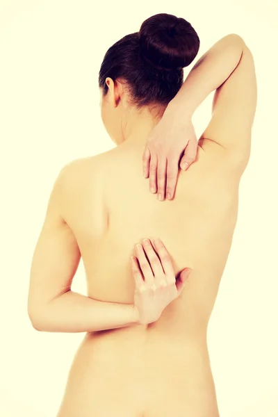 Woman with backache from behind — Stock Photo, Image